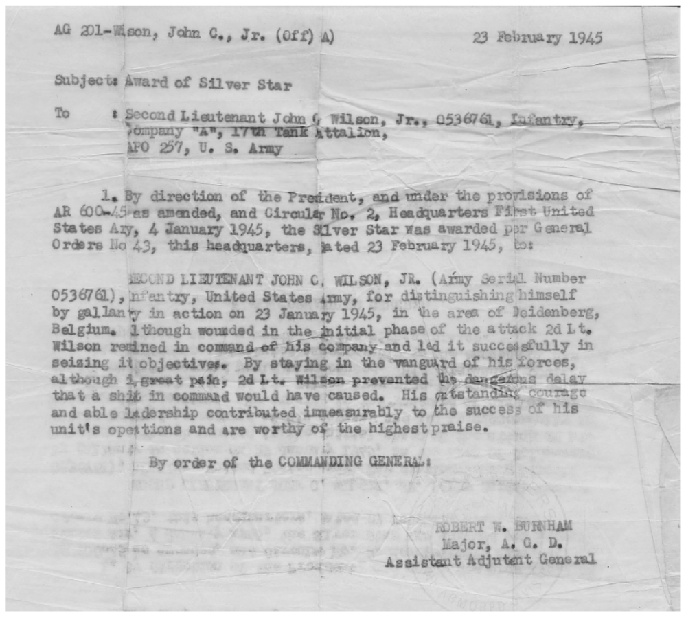 Official U.S. Army Silver Star award document dated February 23, 1945, for Second Lieutenant John C. Wilson Jr., citing his gallantry on January 23 near Deidenberg, Belgium — wounded, he remained in command and led his company to its objectives.